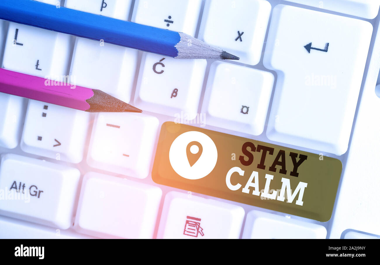 Handwriting text Stay Calm. Conceptual photo Maintain in a state of motion smoothly even under pressure White pc keyboard with empty note paper above Stock Photo