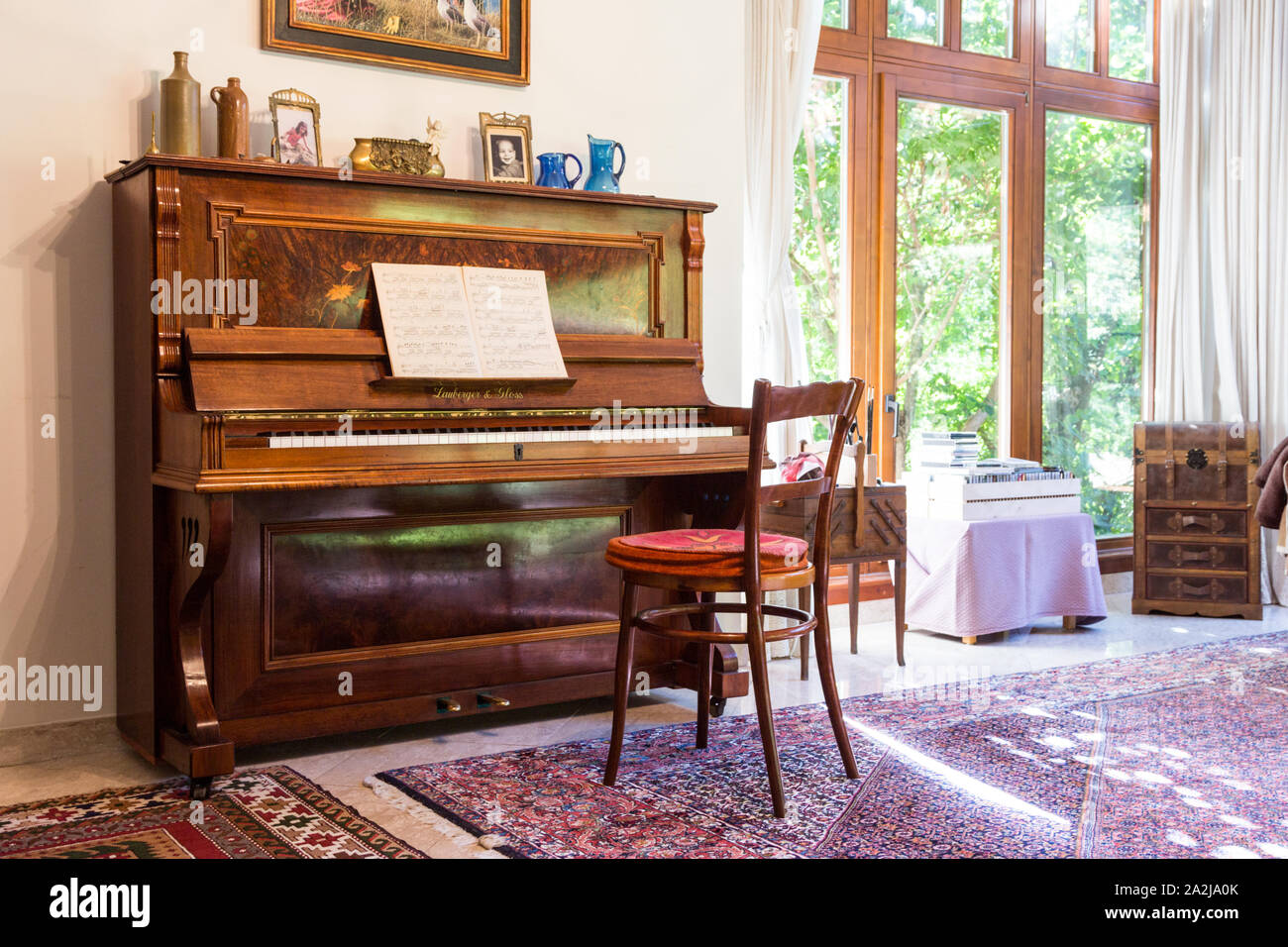 Lauberger & Gloss classic antique upright piano with open sheet music in  bright living room, Lőverek, Sopron, Hungary Stock Photo - Alamy
