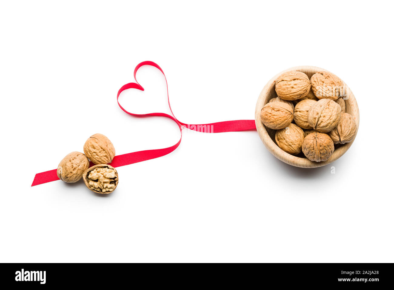 Three nuts a day for heart health, walnuts on bowl on white background Stock Photo