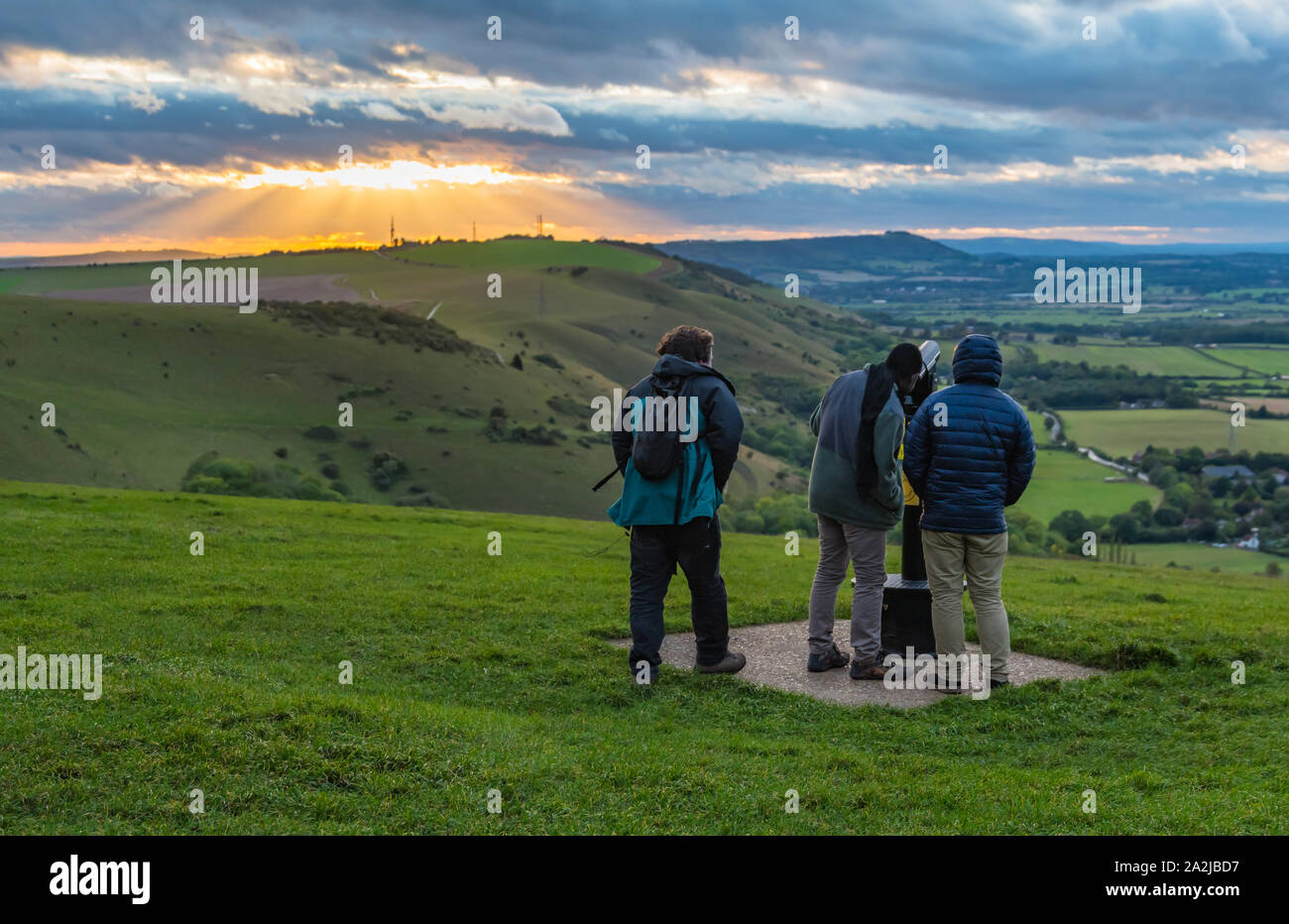 Young male friends looking at the evening view of the South Downs in the Mid Sussex district of West Sussex, England, UK. Stock Photo