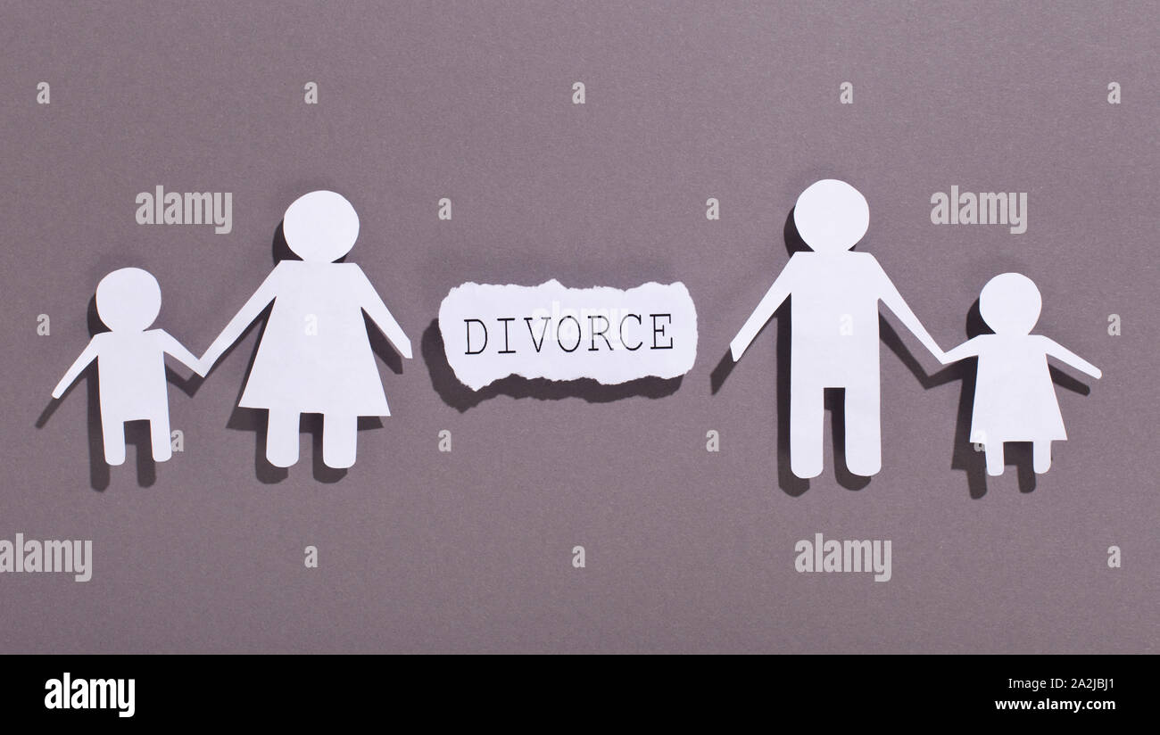Family divorcing and separating children on gray background Stock Photo