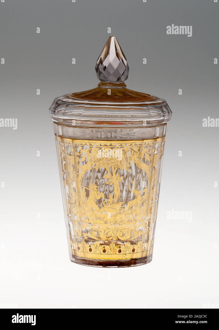 Covered Beaker with Coat of Arms and Hunting Scene, c. 1730, Bohemia, Czech Republic, Bohemia, Glass with engraved gold leaf decoration, 22 × 7.3 cm (8 5/8 × 2 7/8 in Stock Photo