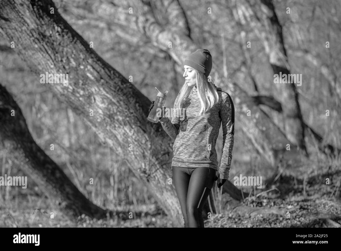 Finess girl resting after running in the autumn park Stock Photo