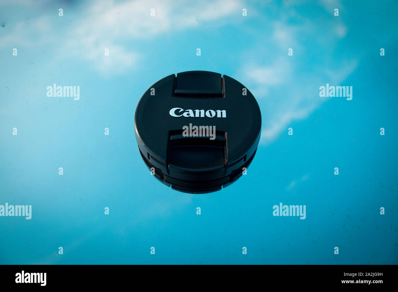 Canon cap, on glass in sky background. Stock Photo