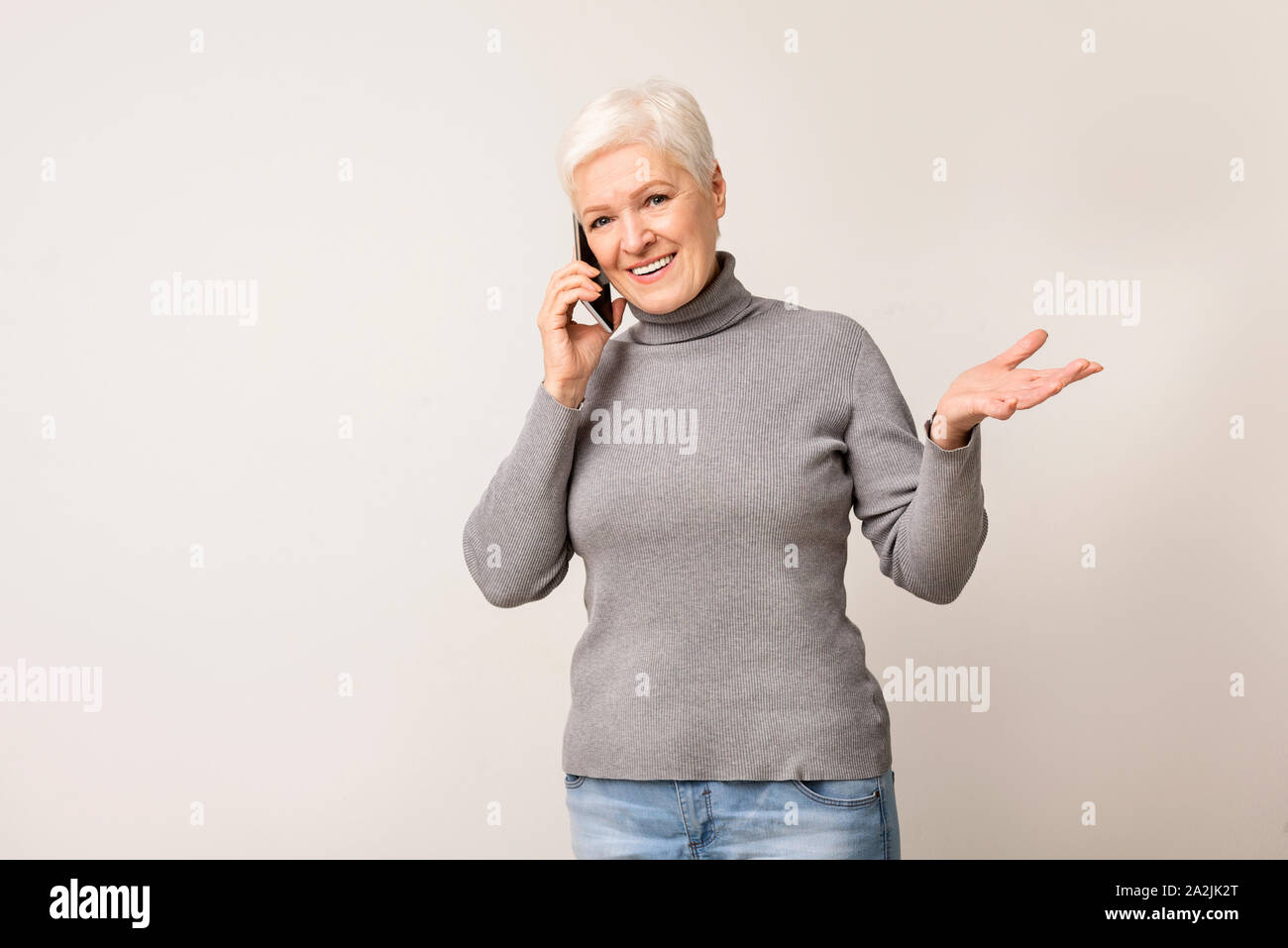Attractive senior woman talking on mobile phone Stock Photo - Alamy