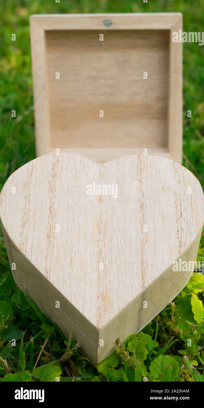 Closed box in the shape of a heart in an open wooden cube box Stock ...
