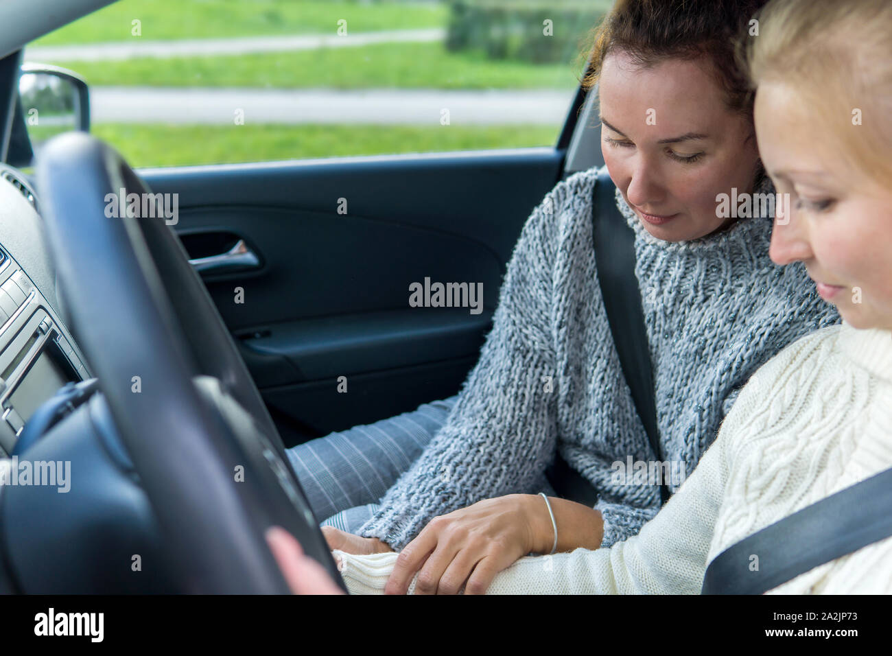 female driving instructor conducts a practical lesson with a female student Stock Photo