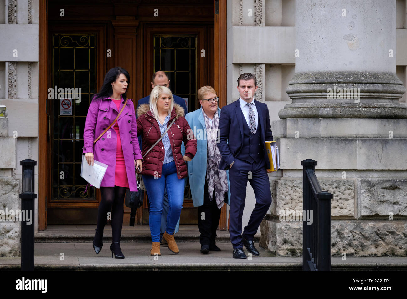 Belfast, Northern Ireland, UK. 3rd October, 2019.  Sarah Ewart (burgundy), her mother Jane Christie (light blue) and Grainne Teggart of Amnesty International (mauve) and legal team leaving Belfast the Belfast High Court following ruling. Today the High Court delivered a judgment in favour of Ms.Ewart that the Northern Ireland’s abortion laws were in breach of  UK’s human rights commitments.   Credit: JF Pelletier/Alamy Live News. Stock Photo