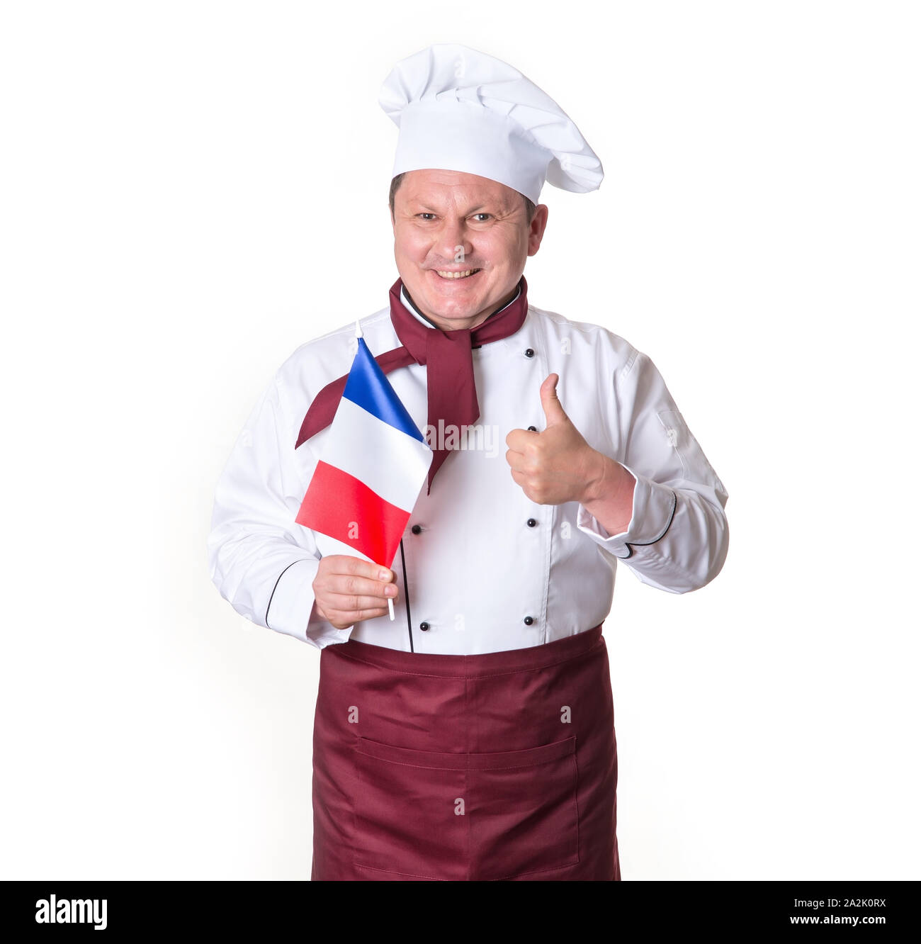 Chef with a flag of France on a light background. Portrait happy middle aged cook man thumbs up. Stock Photo