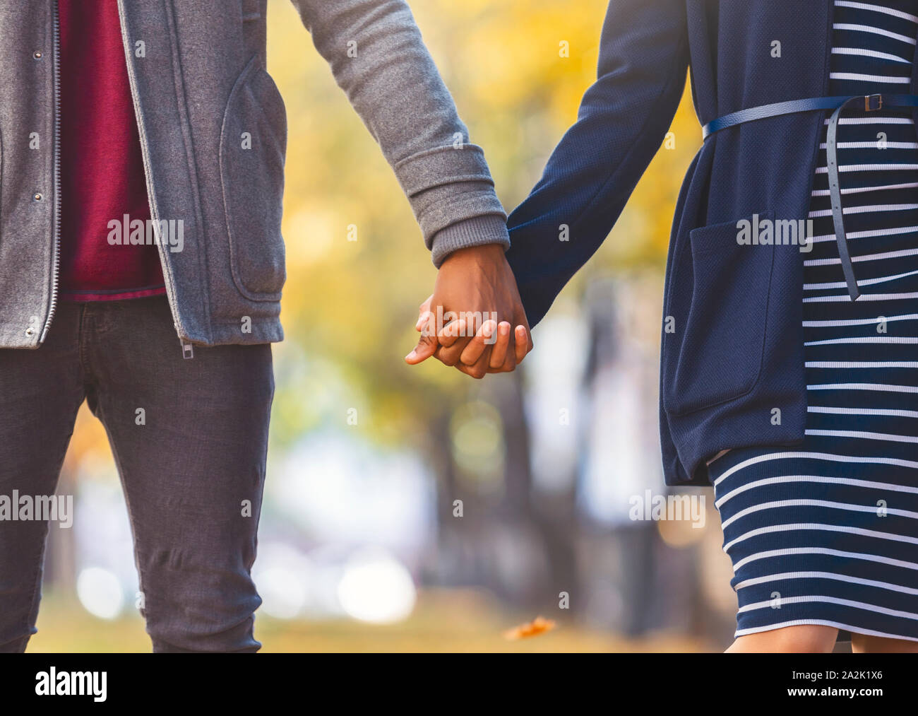African american couple in love holding hands while walking Stock Photo ...