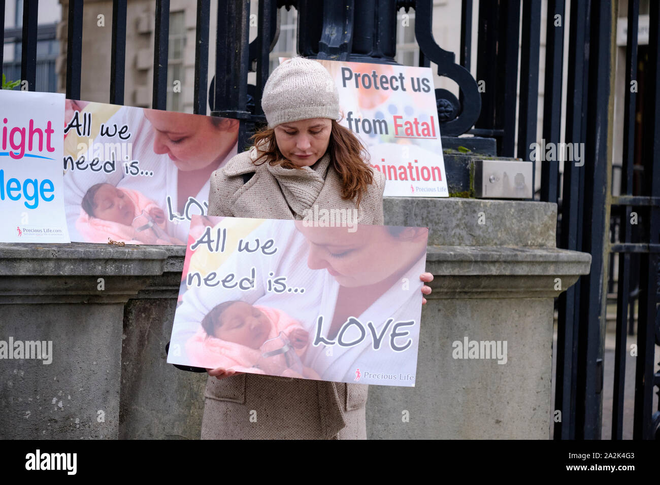 Pro life protesters outsider the Belfast High court with sign 'all we need is love' with newborn infant Stock Photo