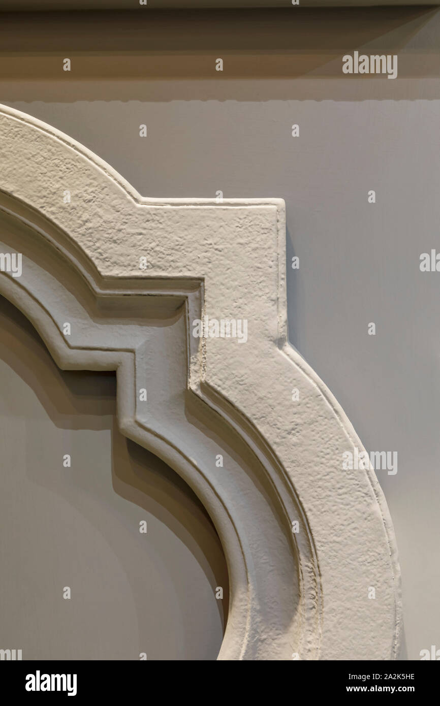 Decorative fragment of the frame on the grey wall. Stock Photo