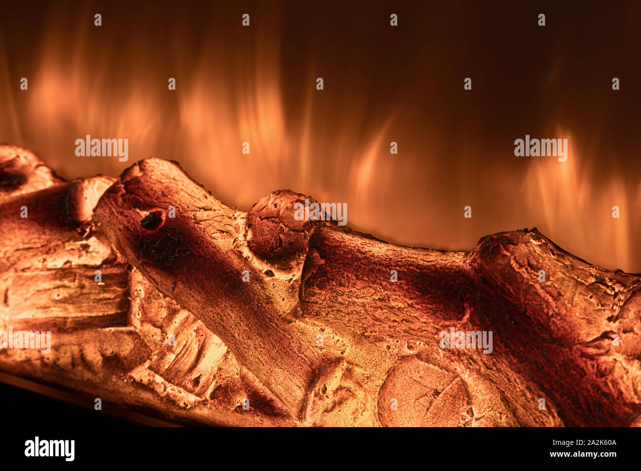 Electric fireplace with fire and firewood closeup. Stock Photo