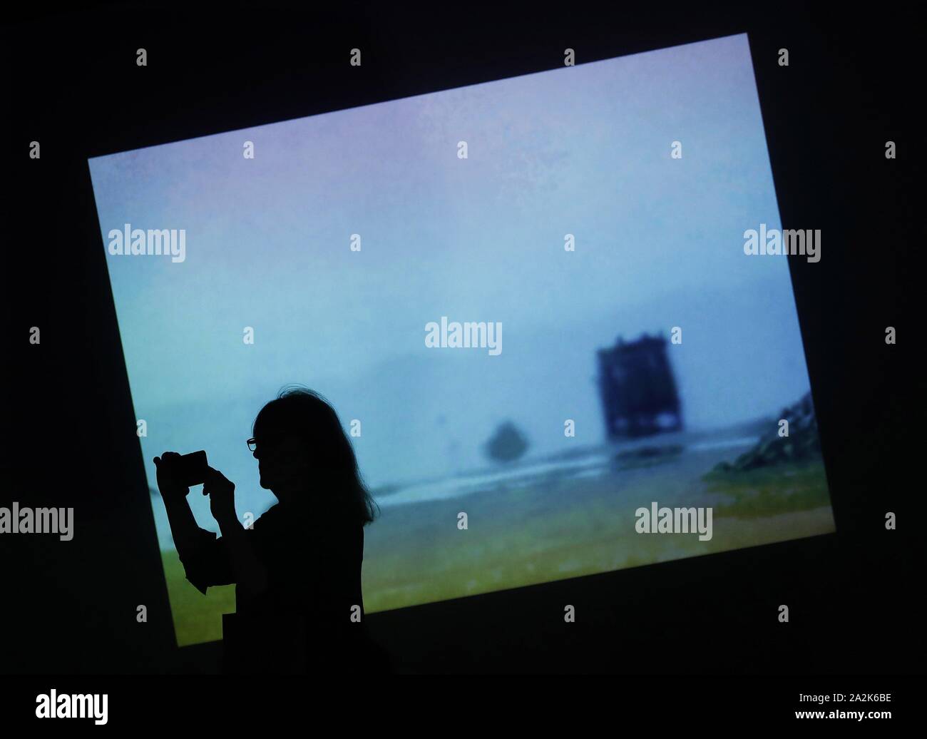 A visitor takes a photo during the presentation of the exhibition 'Bill  Viola: Mirrors of the Unseen' in Barcelona, northeastern Spain, 03 October  2019. The exhibition features some 40 works by the