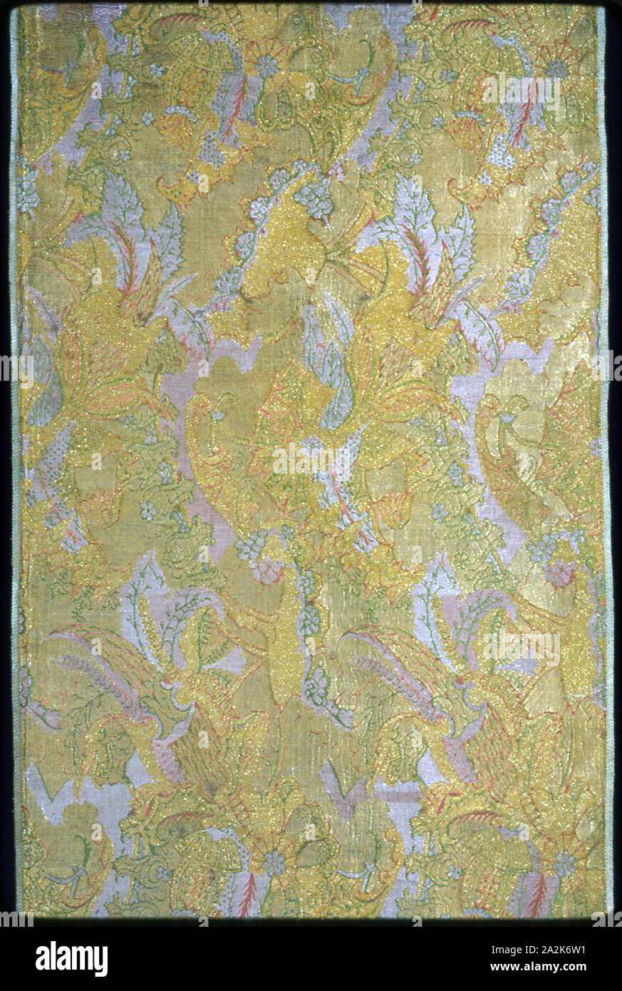 Panel (Dress Fabric), c. 1718/19, France, Silk, gilt-metal-strip-wrapped silk, warp-float faced 7:1 satin weave with secondary binding warps tying supplementary patterning wefts, supplementary brocading wefts, and self-patterning ground wefts in 3:1 and 2:2 twill interlacing, 247.5 × 52.3 cm (97 3/8 × 20 5/8 in Stock Photo