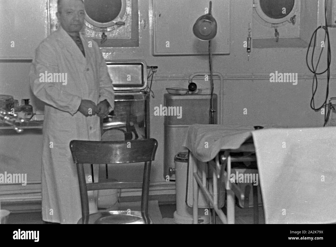 Schiffarzt an Bord des Walfangfabrikschiffs 'Jan Wellem' in seiner Arztpraxis, 1930er Jahre. Ship's doctor of the factory vessel 'Jan Wellem' at his surgery, 1930s. Stock Photo