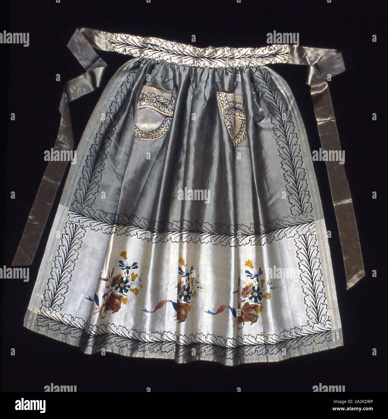 Apron, 1800/25, Switzerland, Silk, plain weave with supplementary patterning warps, block printed and stencilled or painted, two selvages present, ribbon ties: warp-float faced satin weave, 68.5 x 86.6 cm (27 x 34 1/8 in Stock Photo
