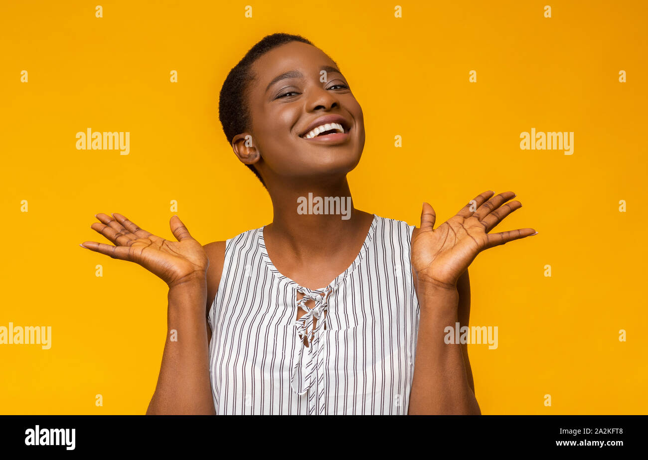 Super happy afro girl raising her hands up Stock Photo