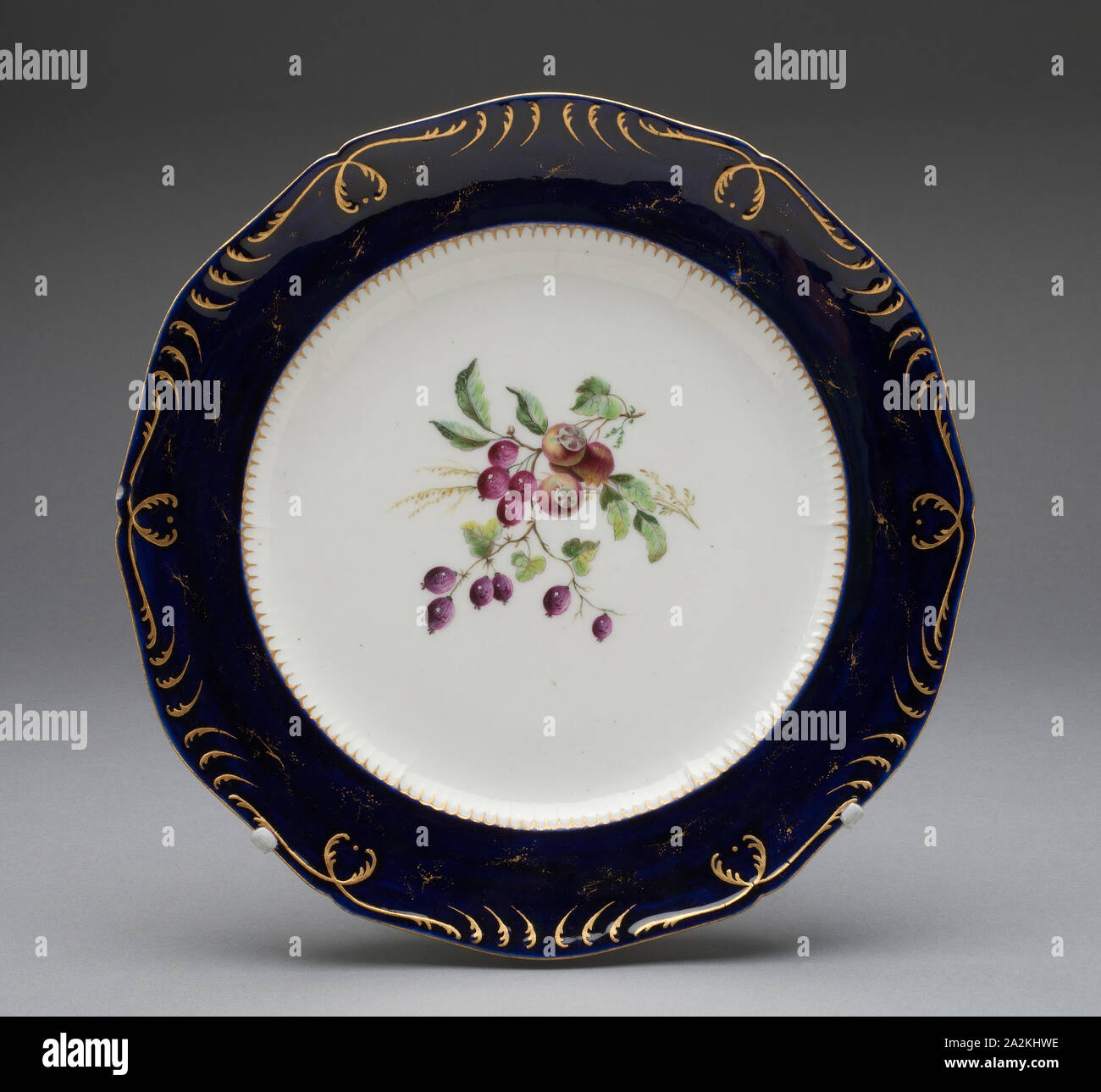 Plate, c. 1752, Vincennes Porcelain Manufactory, French, founded 1740 (known as Sèvres from 1756), Vincennes, Soft-paste porcelain, dark blue ground, polychrome enamels, and gilding, H. 3.5 cm (1 3/8 in.), diam. 25.2 cm (9 15/16 in Stock Photo