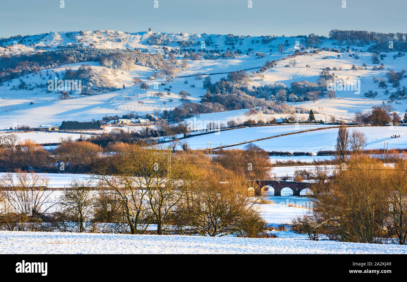 Snow covered Bredon hill and Eckington bridge over the Avon in the
