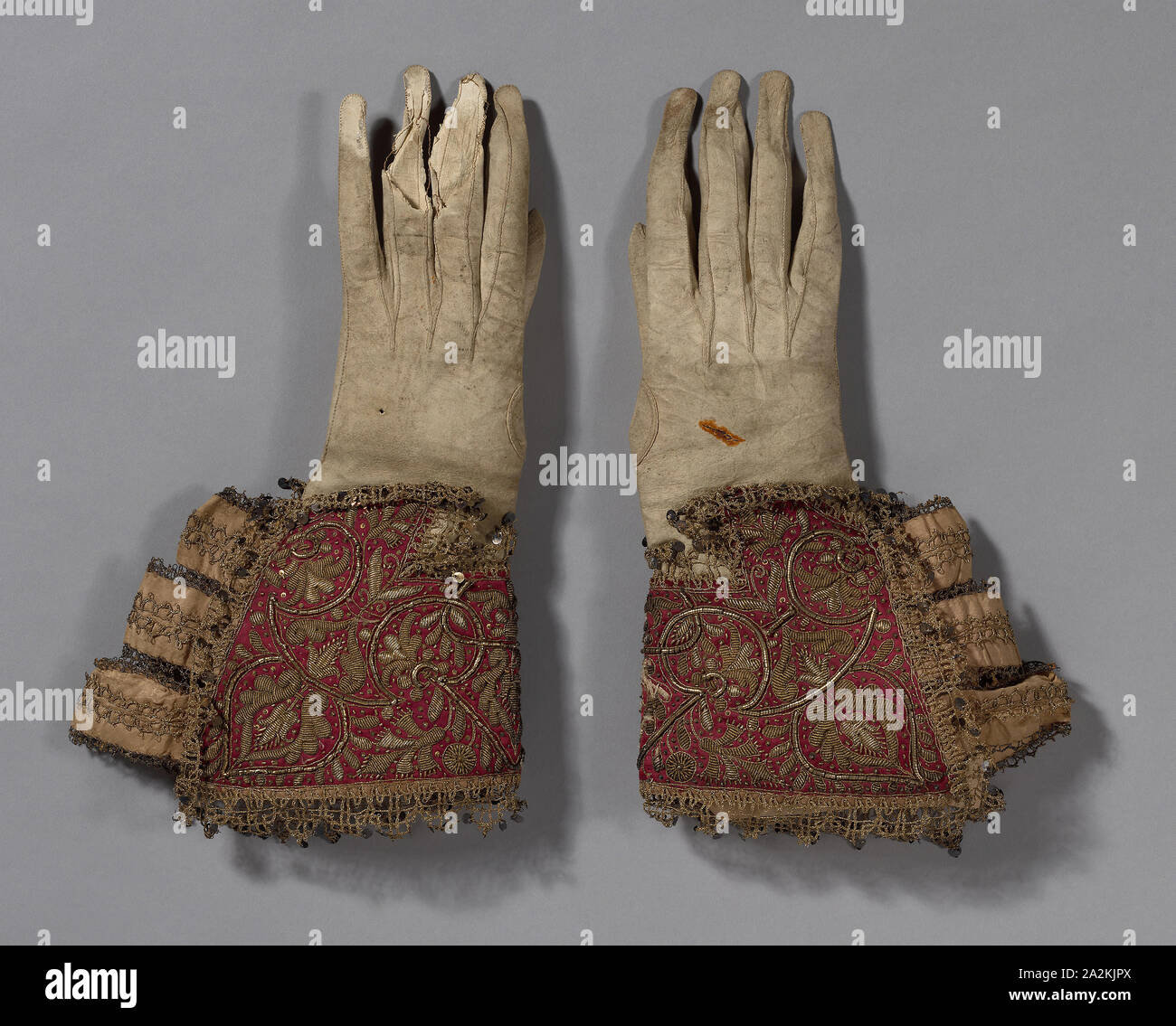 Pair of Men’s Gloves, 1600/50, England, Gloves: leather, Gauntlets: silk, satin weave, embroidered with linen, gilt-metal-coiled wire and strips, and gilt-metal-strip-wrapped silk in couching and padded couching, ribbons of silk, plain weave, edged with gilt-metal-strip-wrapped silk, bobbin straight lace, metal spangles, a: 35.5 × 19.2 cm (14 × 7 1/2 in Stock Photo