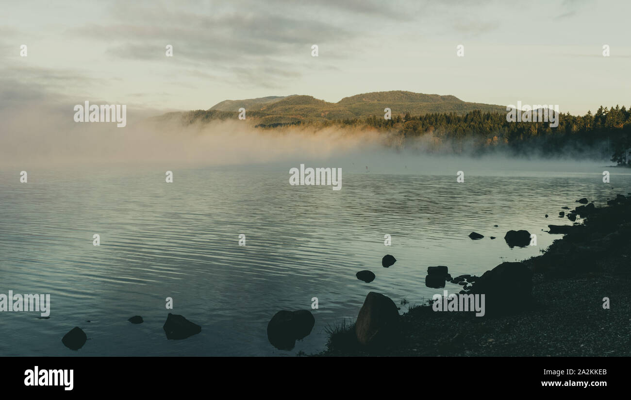 Symmetry between mist and mountain Stock Photo