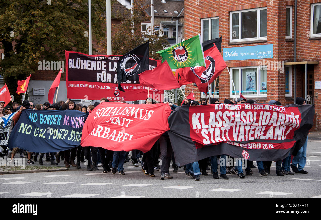 Kiel, Germany. 03rd Oct, 2019. Participants of a demonstration against the unification celebration go during the central celebration to the day of the German unity by the city center. Schleswig-Holstein, as the state with the current presidency of the Bundesrat, is hosting the central celebration on 3 October this year. The Day of German Unity is intended to commemorate German reunification, which took place on 03 October 1990. Credit: Daniel Bockwoldt/dpa/Alamy Live News Stock Photo