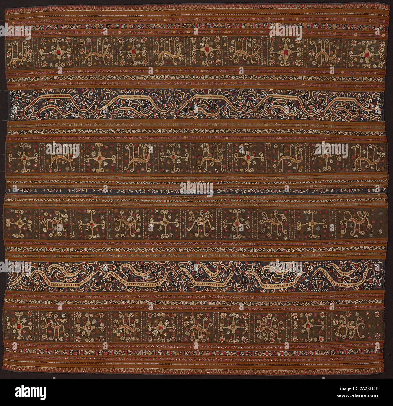 Ceremonial Skirt (tapis), Early 19th century, Abung people, Indonesia, South Sumatra, northern Lampung area, Monggala, Indonesia, Two panels joined: cotton and silk, stripes of warp-faced, weft ribbed plain weave, warp-faced, weft ribbed plain weave with supplementary brocading wefts, and warp resist dyed (warp ikat) plain weave with supplementary brocading wefts, appliquéd with wool, plain weave, embroidered with silk, cotton, pineapple fiber, silver-leaf-over-lacquered-paper strip wrapped cotton and silver-leaf-over-lacquered-paper strip wrapped bast fiber (probably ramie) in buttonhole Stock Photo