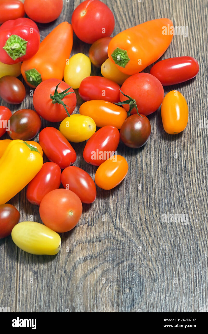 Assortment of Cherry Tomatoes and Paprika Peppers on table Stock Photo