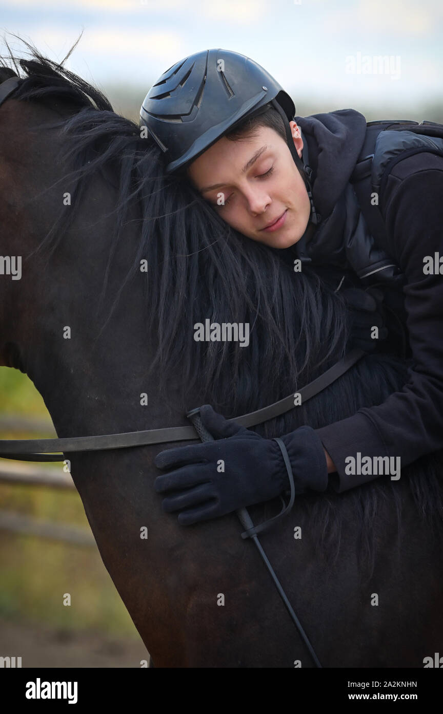 Teenage boy with a horse in nature Stock Photo