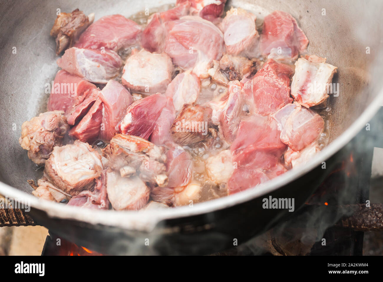 Beef pieces on bones stew in a cauldron. Preparing of Chorba soup