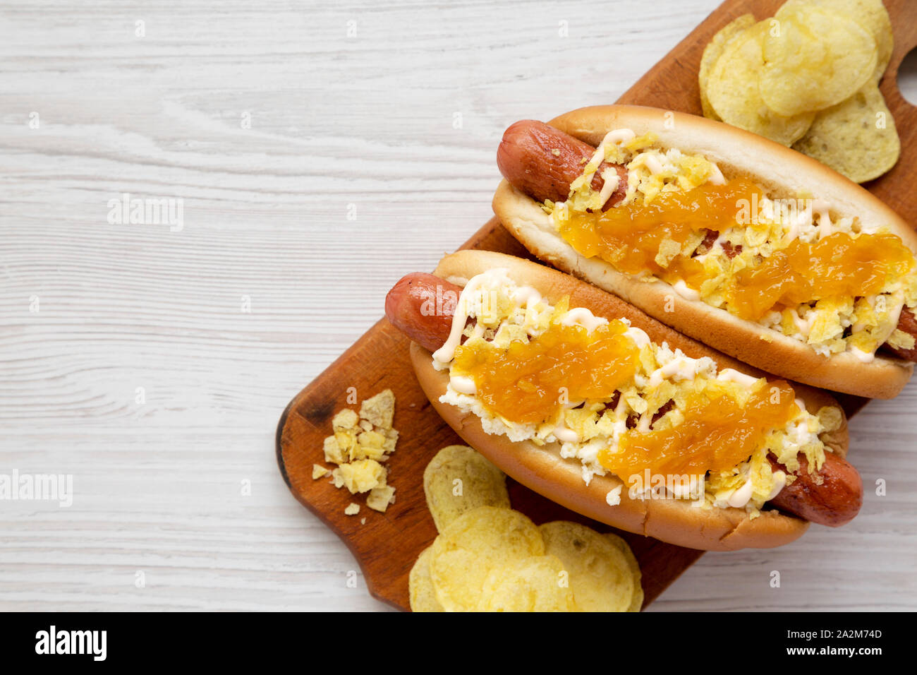 Homemade colombian hot dogs with pineapple sauce, chips and mayo