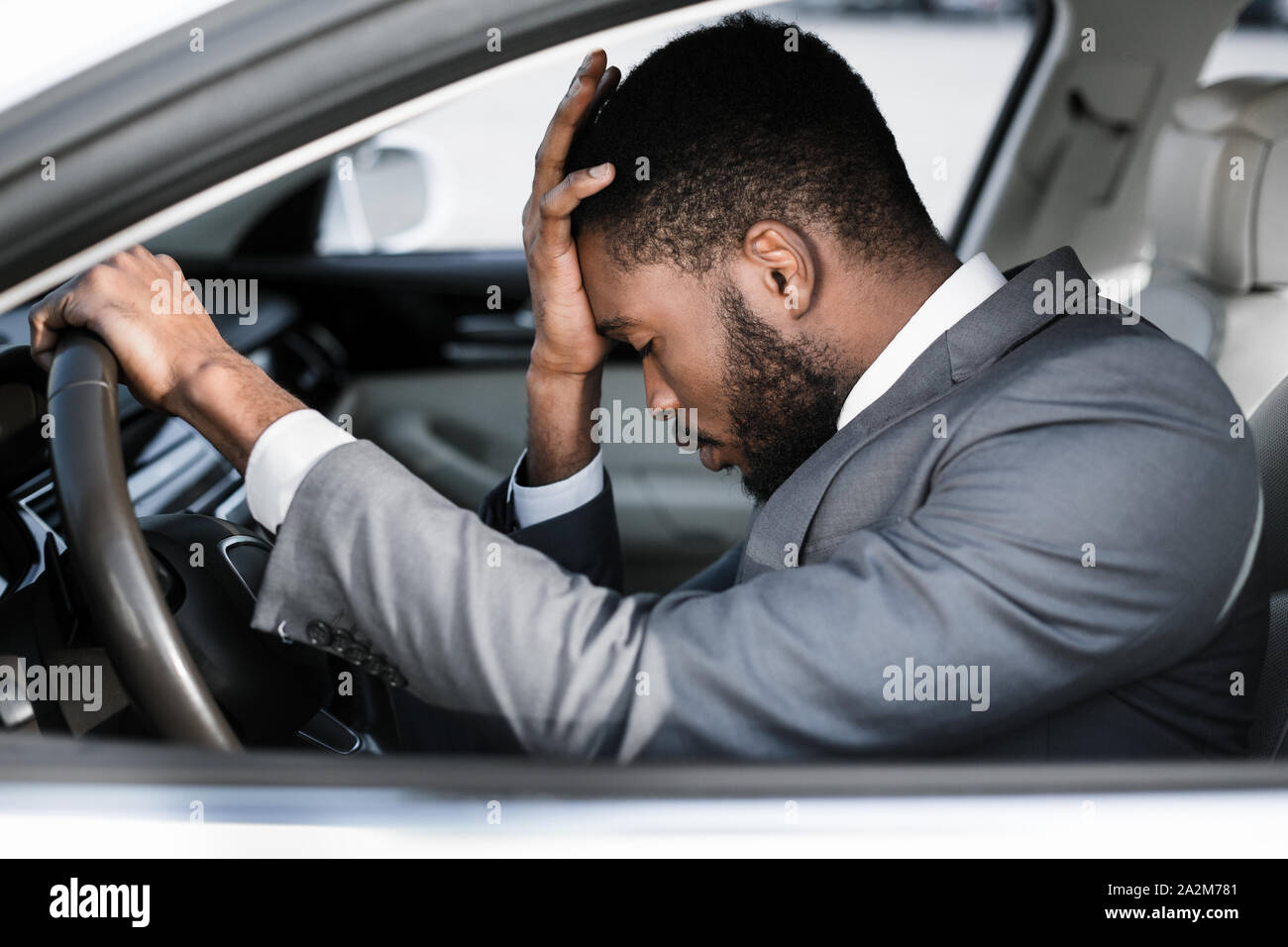 Stressed businessman feeling headache in car, stop the car Stock Photo