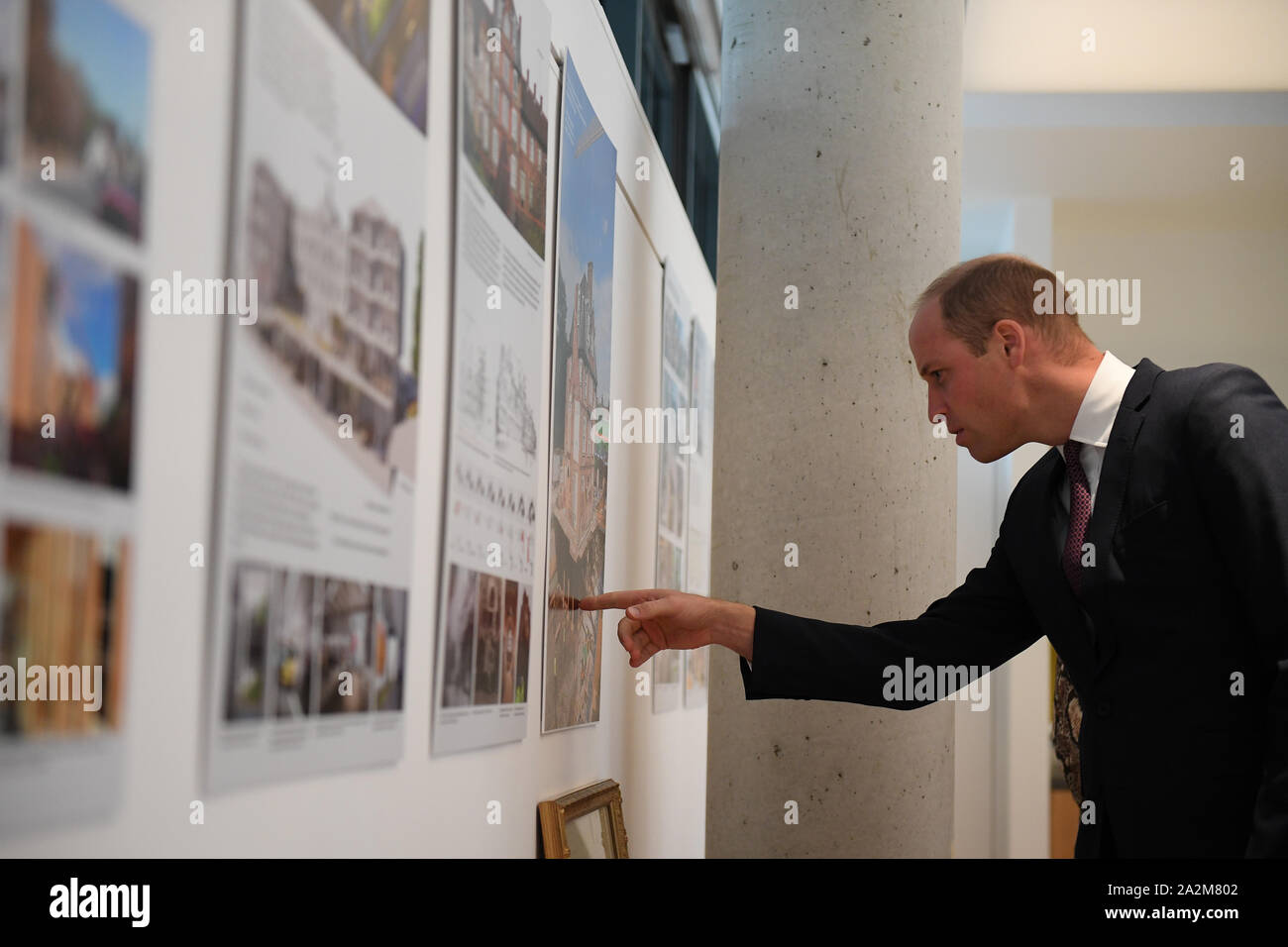 The Duke of Cambridge looks at artwork illustrating the development of the new building at the official opening of Keble College's new graduate building in Oxford. Stock Photo