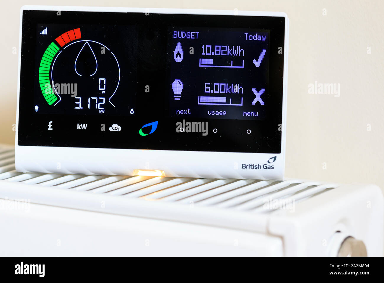 Household British Gas smart meter on radiator to monitor electric and gas consumption thereby saving money for the resident. Shows high energy use. Stock Photo