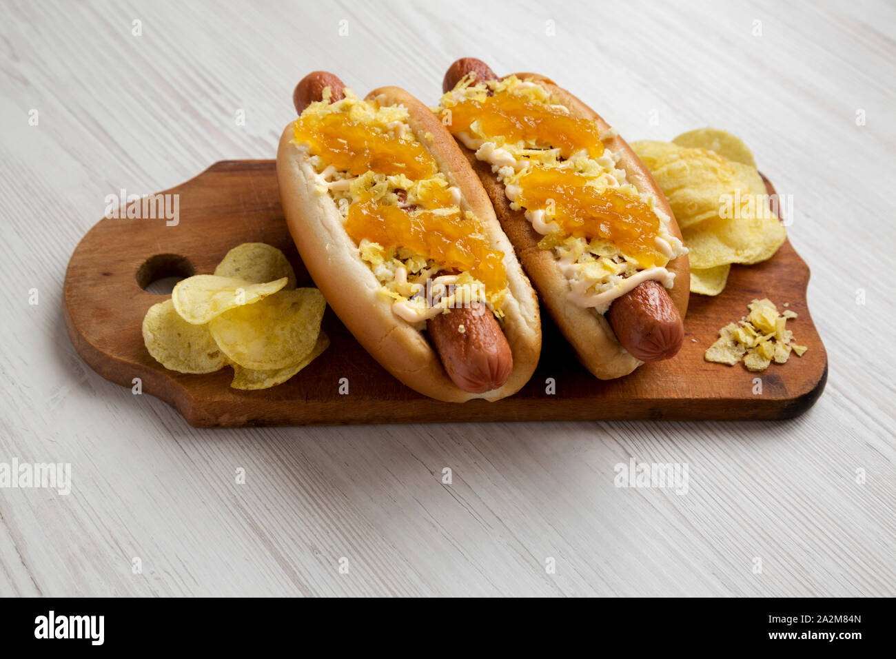 Homemade colombian hot dogs with pineapple sauce, chips and mayo