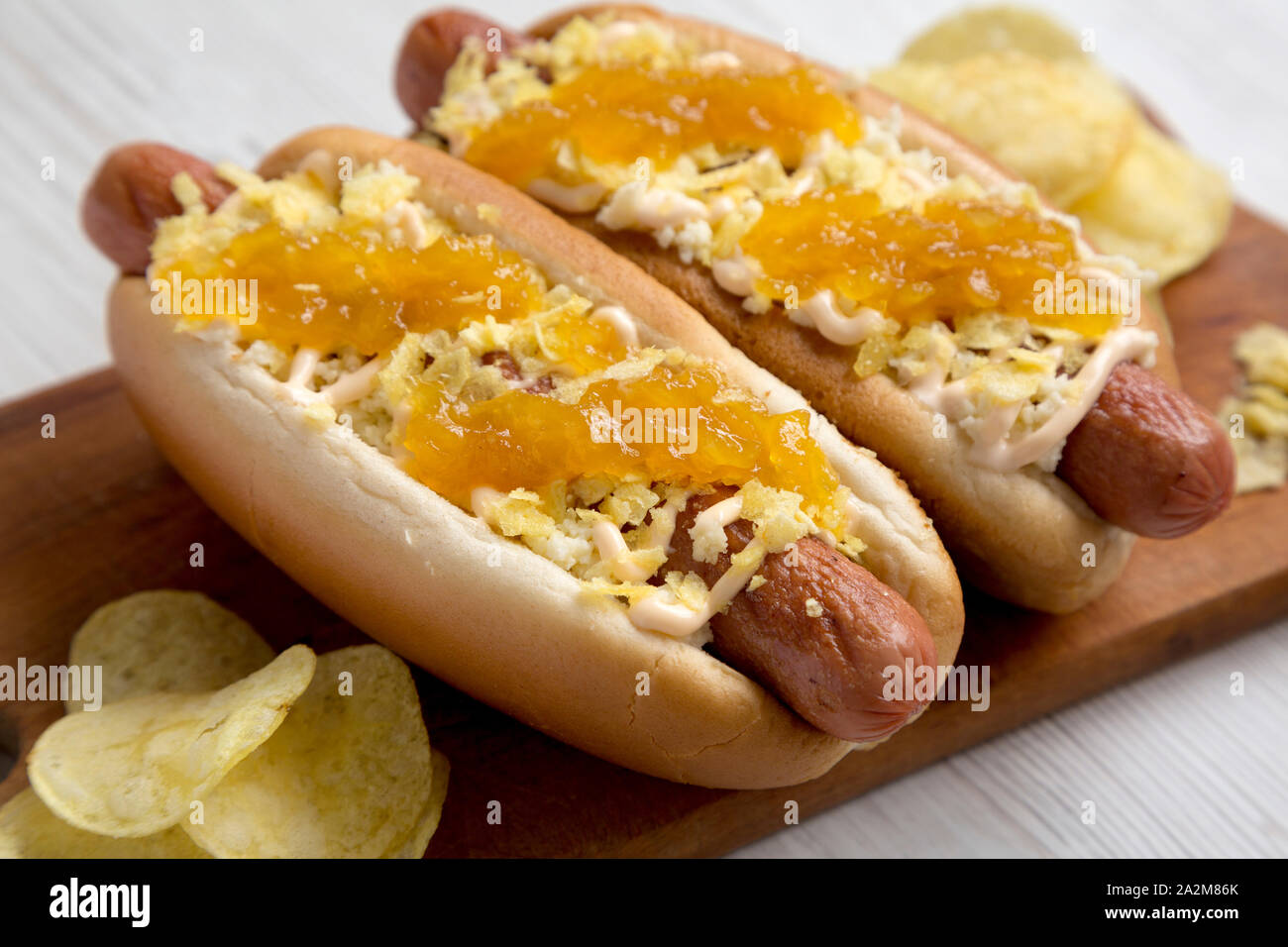 Homemade colombian hot dogs with pineapple sauce, chips and mayo
