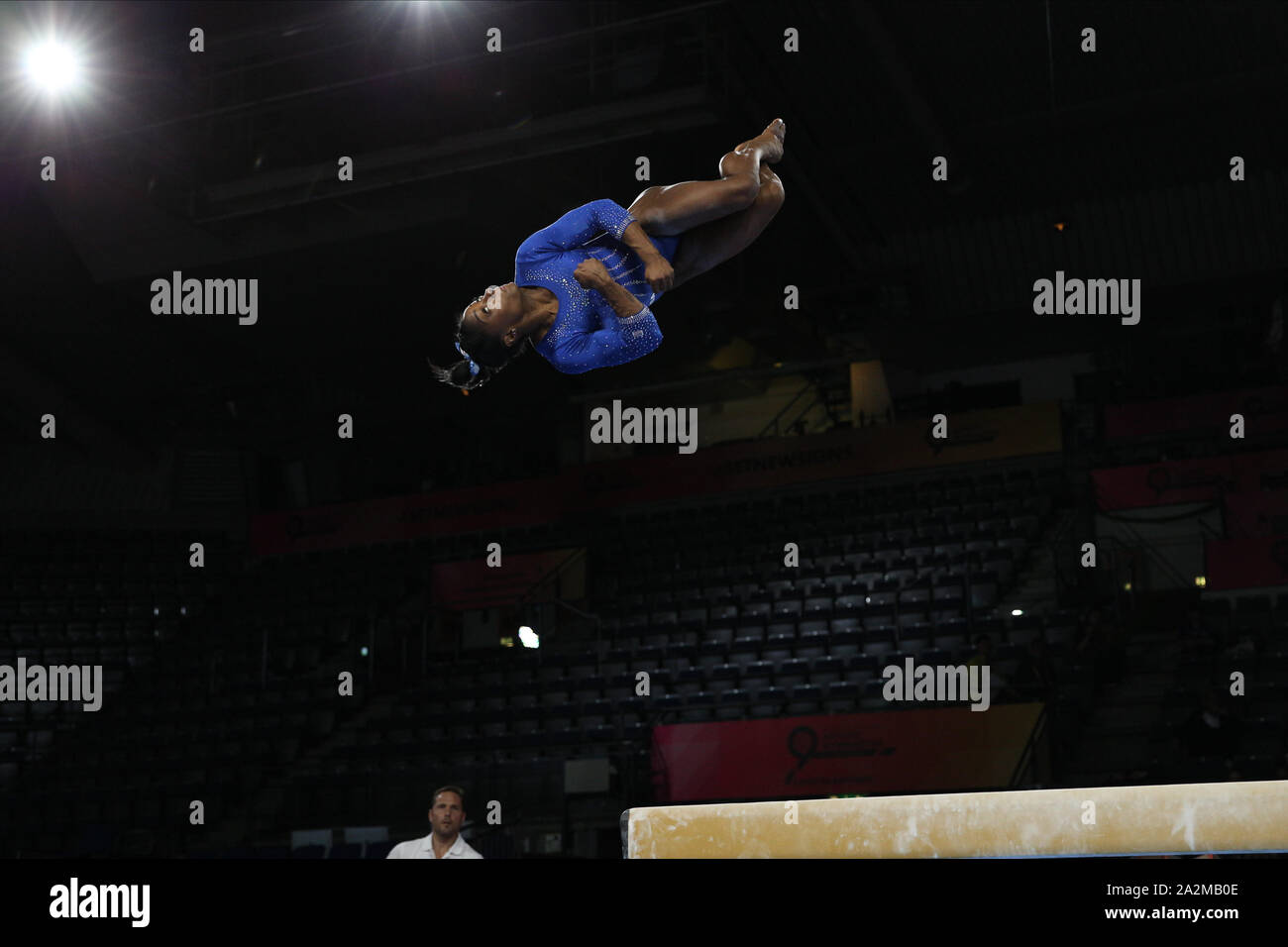 October 1, 2019: Gymnast Simone Biles from the USA during the podium training day at the 2019 World Artistic Gymnastics Championships in Stuttgart, Germany. Biles warms up a double-twisting double back dismount, a skill she hopes will be named after her, while coach Laurent Landi watches. Melissa J. Perenson/CSM Stock Photo