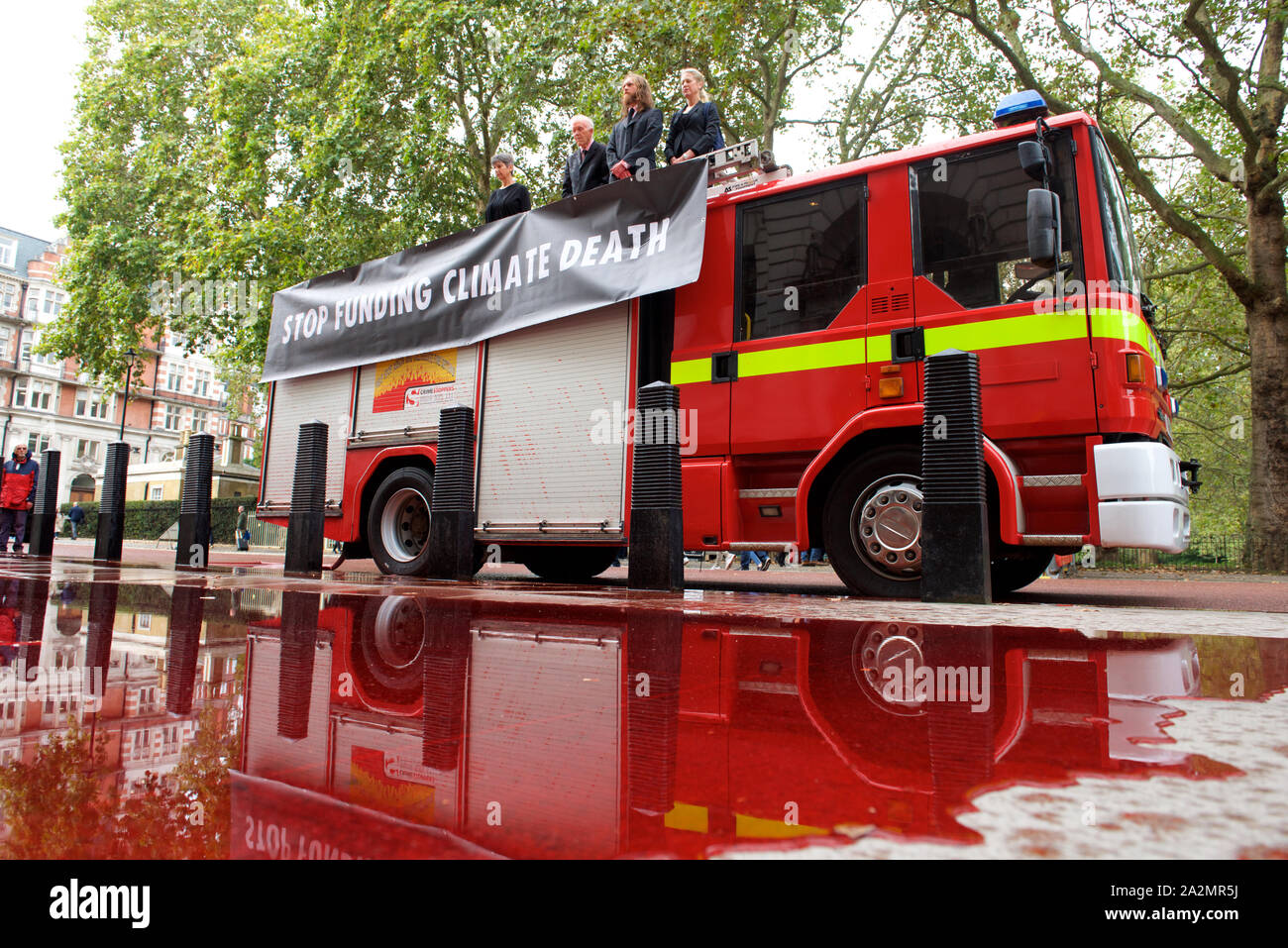 London, UK. 3rd October 2019. Extinction Rebellion activists use fire engine to spray 1,800 litres of fake blood over the front of the Treasury in LondonThe protest highlights the inconsistency between the UK government’s insistence that the UK is a world leader in tackling climate breakdown, and the vast sums it pours into fossil fuel exploration and carbon-intensive projects. Credit Gareth Morris/Alamy Live News Stock Photo