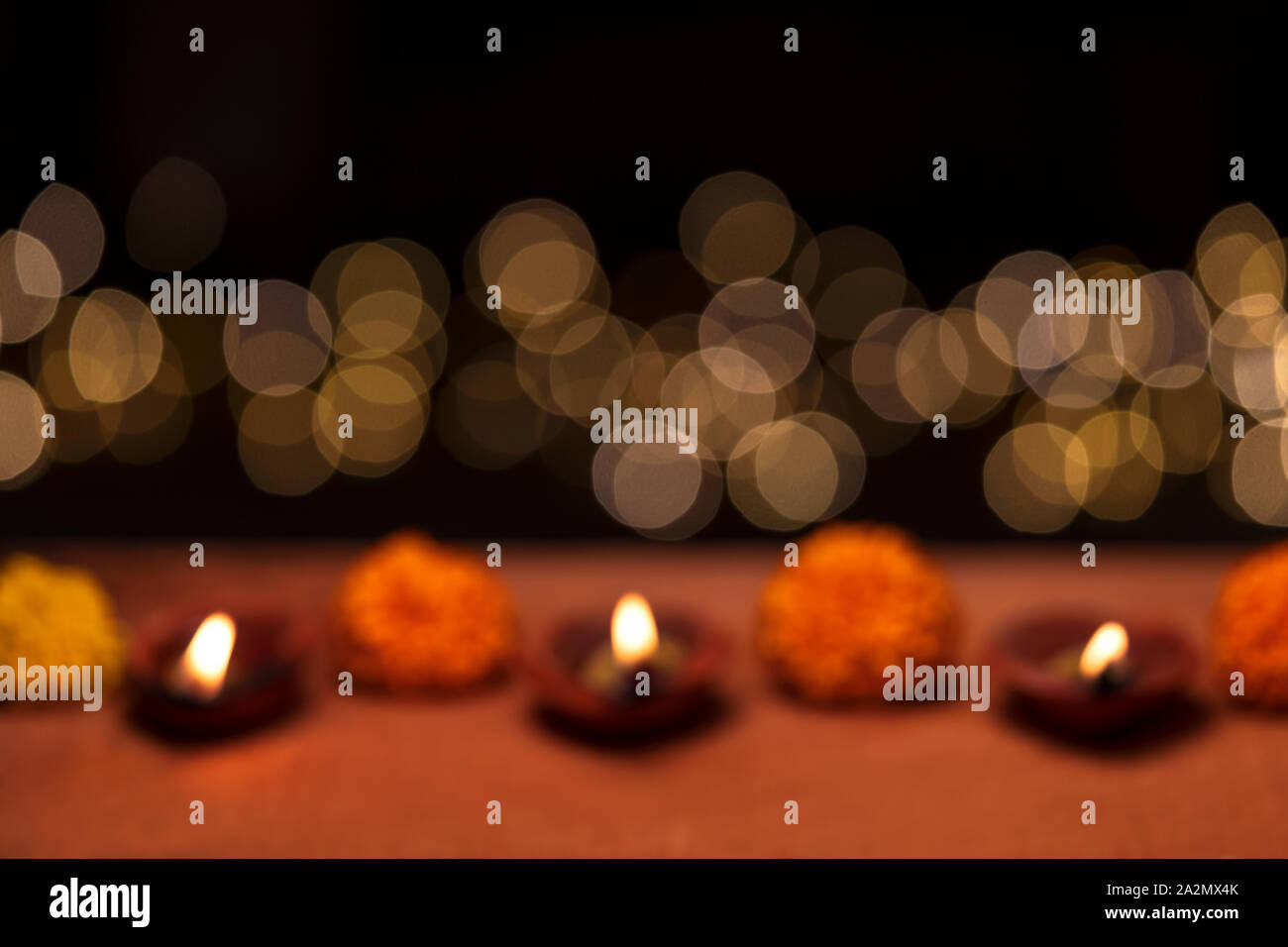 Diwali - an Indian festival of lights which is now celebrated all over the world. An abstract blurred background picture of diya oil lamp with copy sp Stock Photo