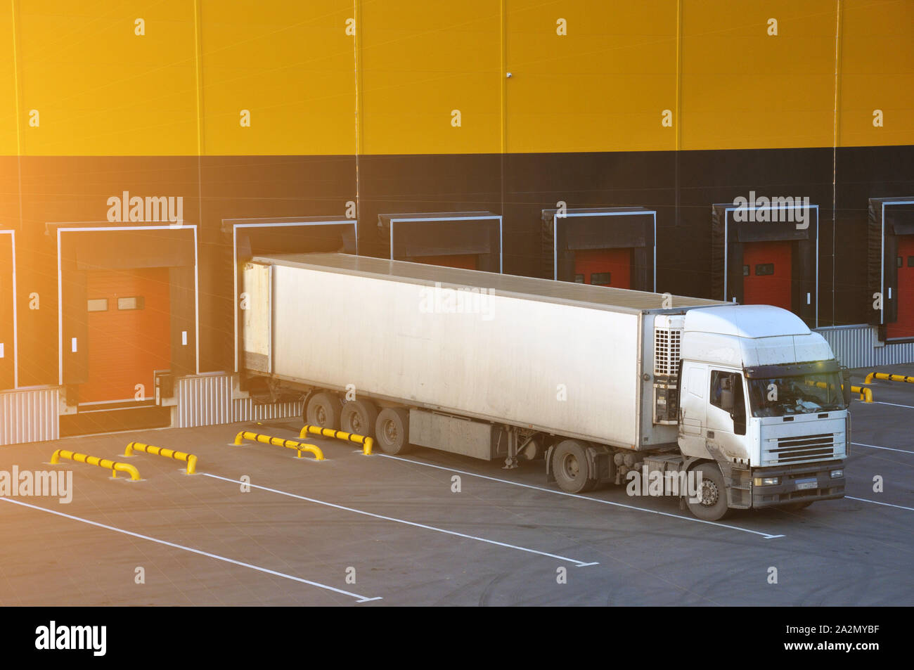 Warehouse Rear Unloading Unloading trucks at a modern warehouse complex. Logistics. Flare Stock ...