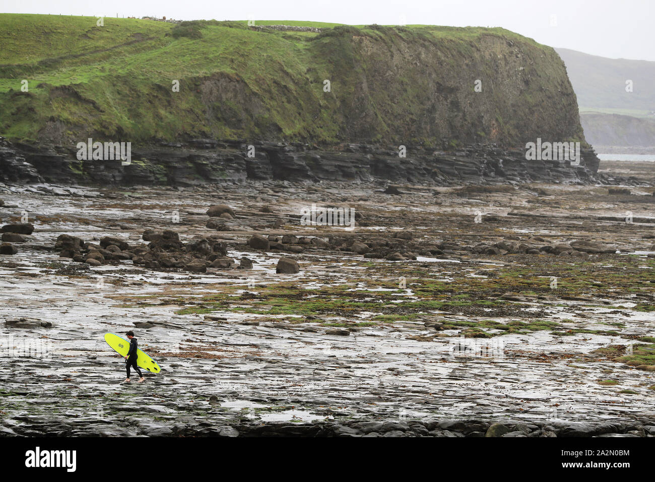 A surfer leaves the water in Lahinch, County Clare, on the West Coast of Ireland as storm Lorenzo is expected to make landfall, with a status orange wind warning and a yellow rain warning having been issued. Stock Photo