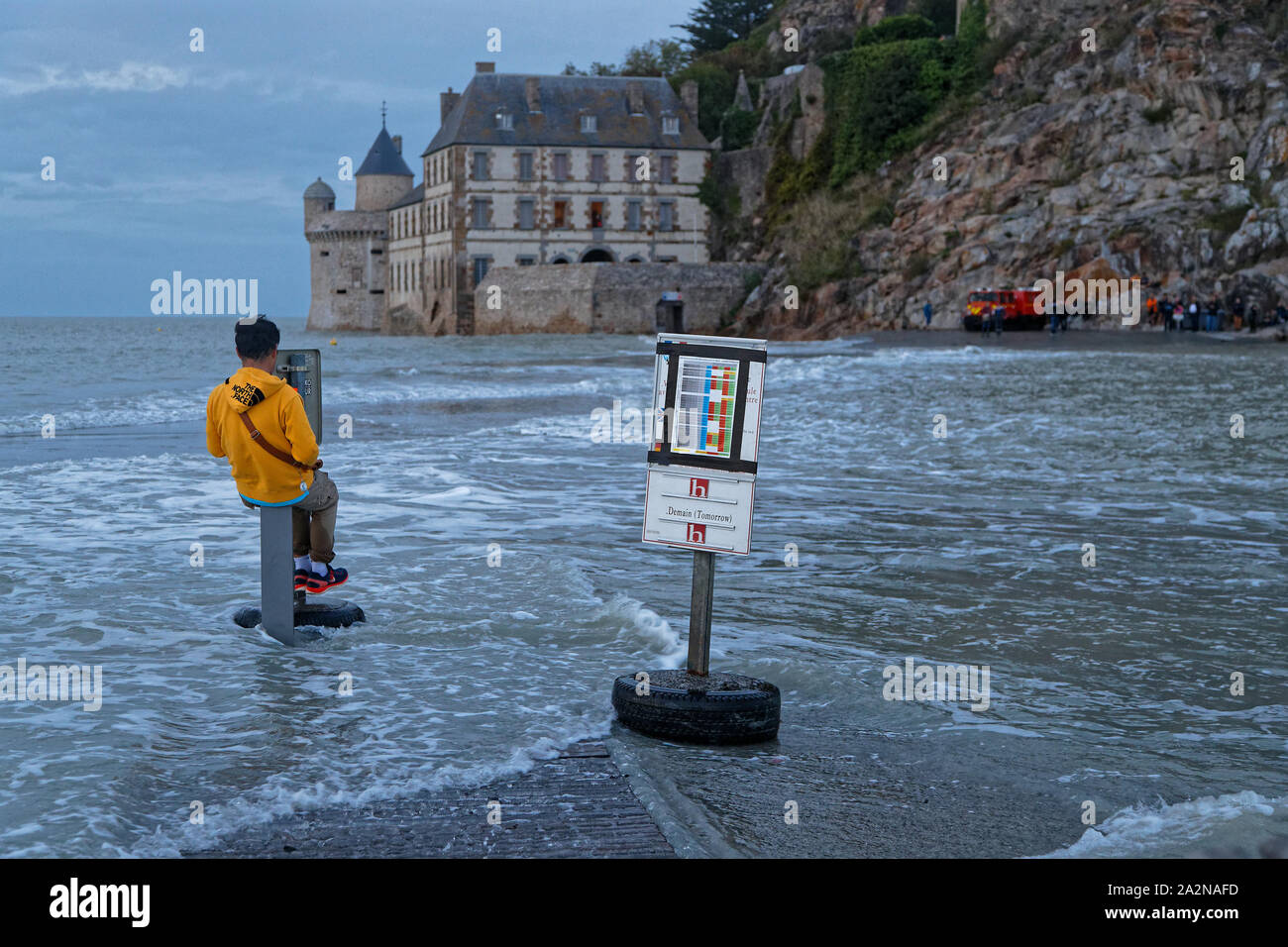 MONT ST-MICHEL, FRANCE, September 28, 2019 : Waiting for the high tide on the passageway to the mount. Mont Saint-Michel and its bay are on the list o Stock Photo