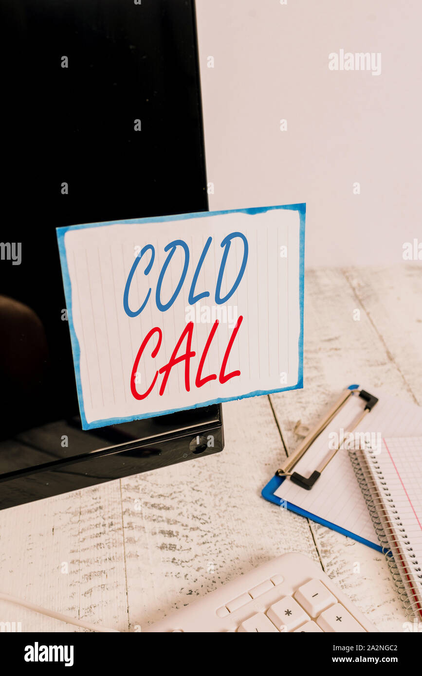Writing note showing Cold Call. Business concept for Unsolicited call made by someone trying to sell goods or services Note paper taped to black compu Stock Photo