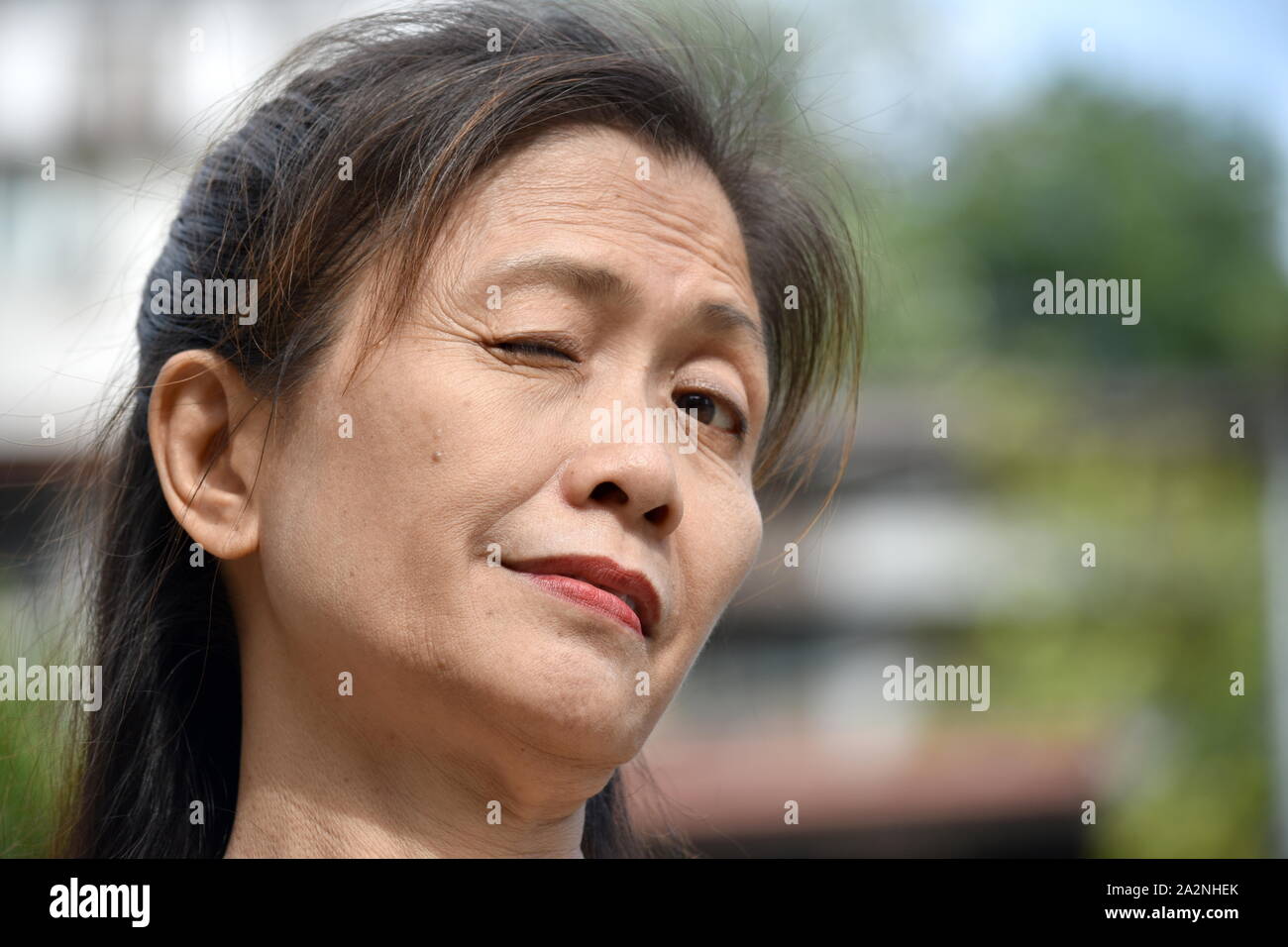 A Winking Filipina Female Senior Stock Photo