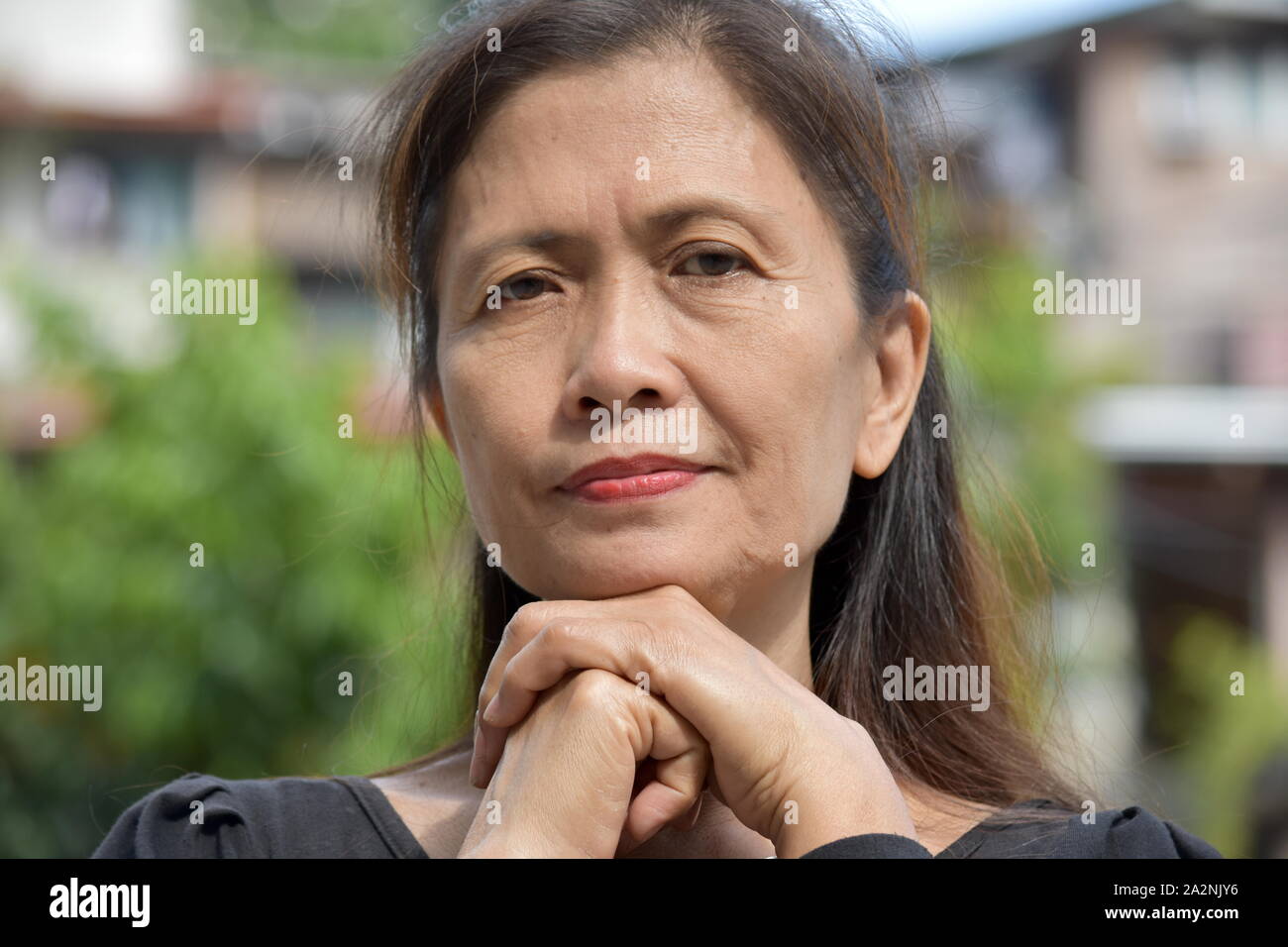 A Serious Filipina Female Senior Stock Photo