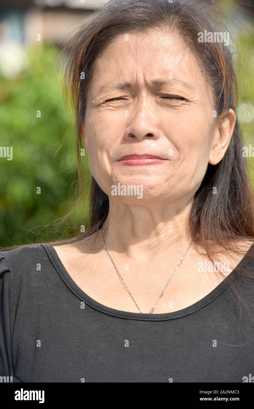 An Asian Female Senior Under Stress Stock Photo