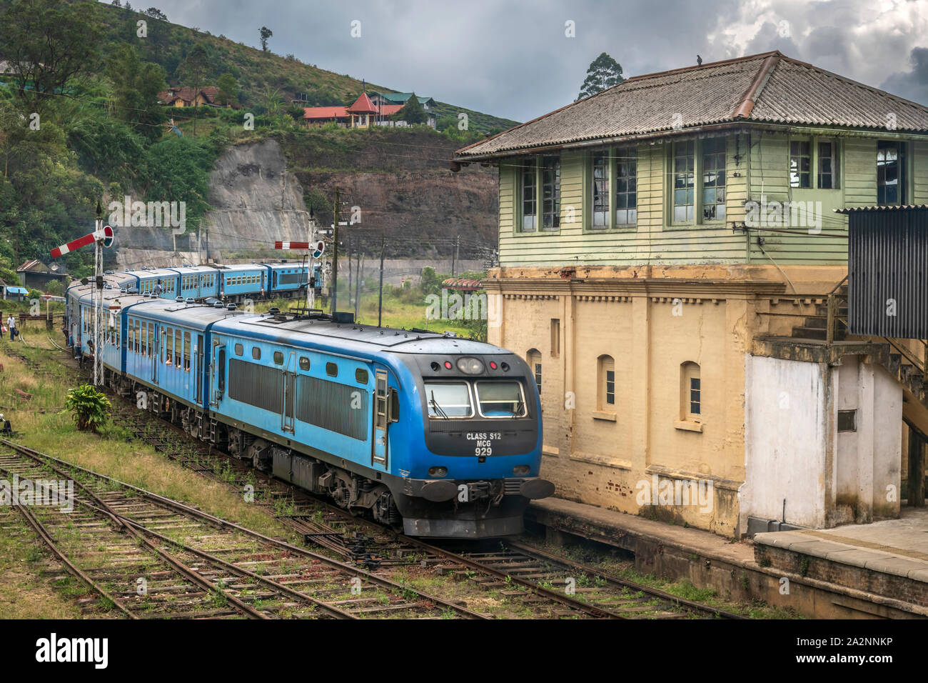 A passenger train departs Nanu Oya Station on a stormy day in the Central Province of Sri Lanka. Stock Photo