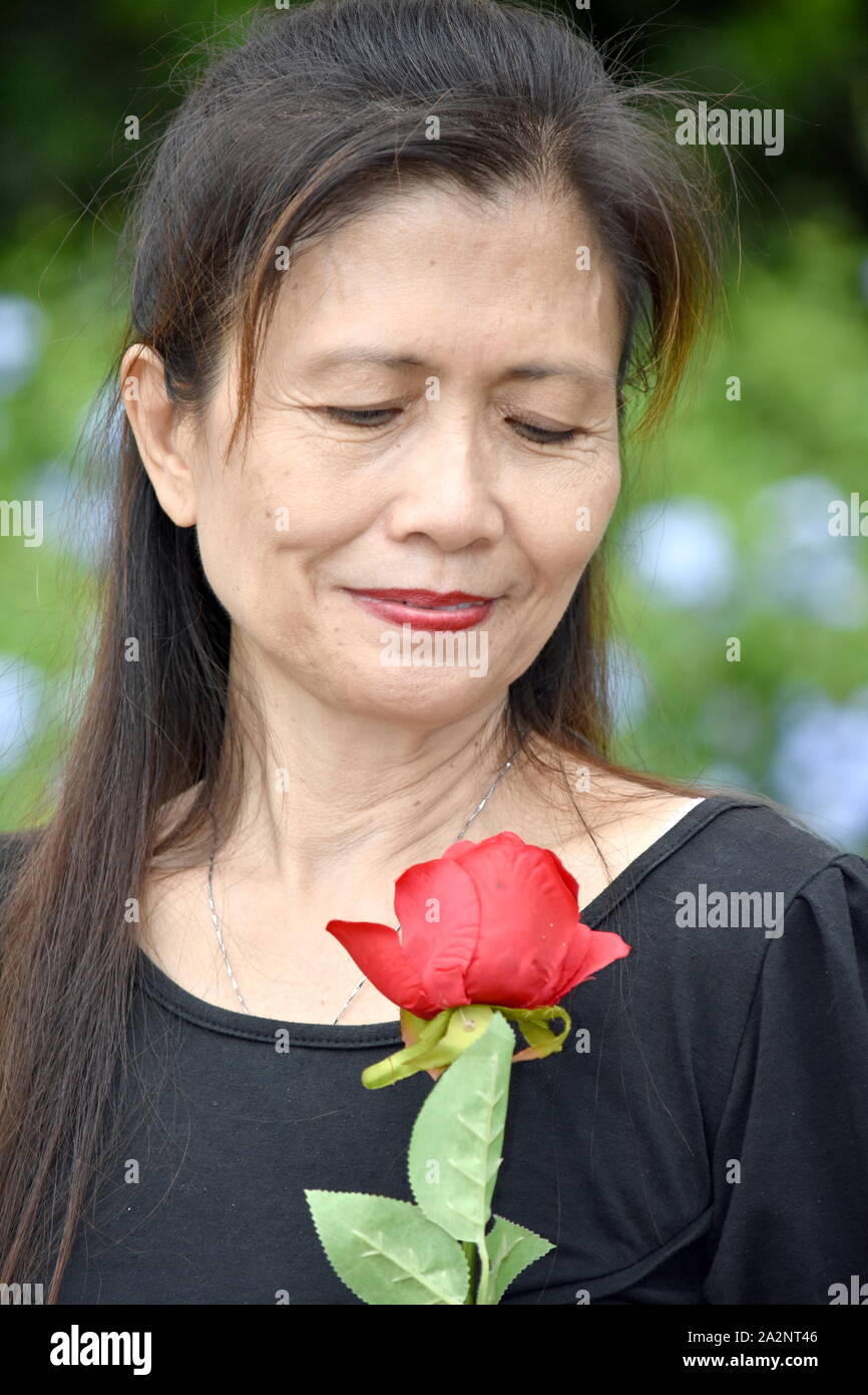 Asian Female Senior And Sadness With A Flower Stock Photo