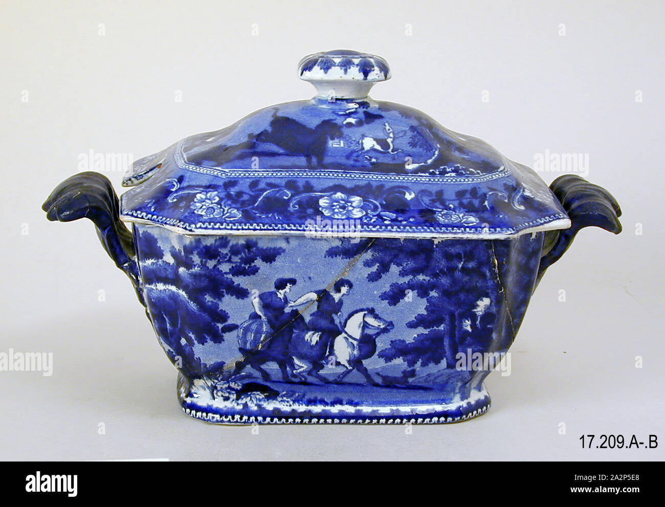 Dr. Syntax Bound to a Tree by Highwaymen; Dr. Syntax Drawing... Gravy Tureen; Dr. Syntax Pursued by a Bull Gravy Tureen Cover, 19th Century, Transfer-printed glazed earthenware, 5 3/8 x 8 3/4 x 4 1/2 in. (13.7 x 22.2 x 11.43 cm Stock Photo